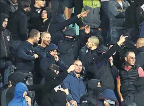 ??  ?? SICKENING The black-clad neo-Nazis of the Lauta Army made fascist salutes and monkey noises, while England boss Gareth Southgate and captain Harry Kane discussed walking off