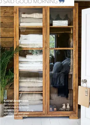  ??  ?? Guest bedroom
Reclaimed scaffoldin­g board cladding brings texture to the room, along with the oak and glass cabinet from NORSK