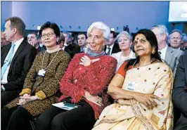  ?? EVAN VUCCI/AP ?? IMF Director Christine Lagarde, center, and other leaders listen as President Donald Trump delivers a speech to the World Economic Forum on Friday in Davos, Switzerlan­d.