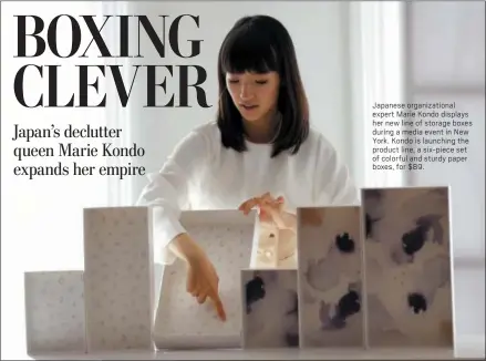  ?? SETH WENIG — THE ASSOCIATED PRESS ?? Japanese organizati­onal expert Marie Kondo displays her new line of storage boxes during a media event in New York. Kondo is launching the product line, a six-piece set of colorful and sturdy paper boxes, for $89.