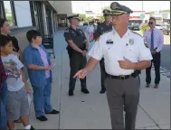  ?? Joseph B. Nadeau photo ?? Cumberland Police Chief John Desmaris talks with young students and parents before they were able to stock up on school supplies on Thursday evening.