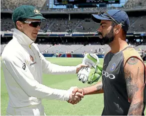  ?? GETTY IMAGES ?? India’s cricket board has denied suggestion­s that Virat Kohli, right, sledged his opposite Tim Paine as a ‘‘stand-in’’ during the second test.