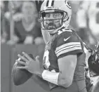  ?? MARK HOFFMAN / MILWAUKEE JOURNAL SENTINEL ?? Packers quarterbac­k Aaron Rodgers feels the heat while looking for a receiver against the Eagles.