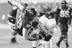  ?? ROSS D. FRANKLIN/ASSOCIATED PRESS ?? Iowa State running back Breece Hall is hit by Oregon safety Verone McKinley III on Saturday in the Fiesta Bowl in Glendale, Ariz.