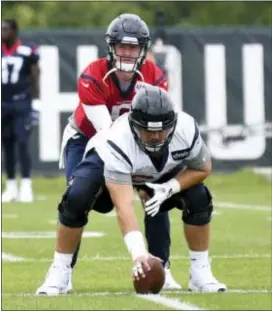  ?? CHRIS TILLEY — THE ASSOCIATED PRESS ?? Texans QB Tom Savage, back, of Cardinal O’Hara, takes a warm-up snap during training camp in White Sulphur Springs, W.Va., Wednesday.