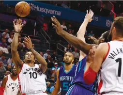  ?? (Reuters) ?? TORONTO RAPTORS guard DeMar DeRozan (10) shoots to score in the Raptors’ 113-111 victory against the Charlotte Hornets at Spectrum Center on Friday.