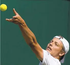  ?? ALASTAIR GRANT AP ?? Tim van Rijthoven of the Netherland­s serves to Georgia’s Nikoloz Basilashvi­li during a third-round men’s singles victory on Friday at Wimbledon.