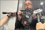  ?? JENNA FRYER / AP ?? NASCAR Cup Series Managing Director Brad Moran shows reporters, Saturday at Las Vegas Motor Speedway, the illegal glove Joey Logano of Team Penske was caught wearing during qualifying last week at Atlanta Motor Speedway.