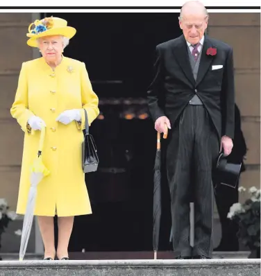  ??  ?? The Queen and Prince Philip take part in a minute’s silence at Buckingham Palace for the Manchester victims