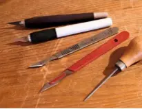  ??  ?? A selection of scalpels and a bradawl, in the foreground, enable Kirstin to cut out even the tiniest section of paper.