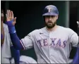  ?? CARLOS OSORIO — THE ASSOCIATED PRESS ?? Texas Rangers designated hitter Joey Gallo is greeted in the dugout after scoring during the sixth inning of a baseball game against the Detroit Tigers, Thursday, July 22, 2021, in Detroit.