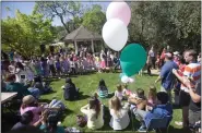  ?? PATRICK TEHAN STAFF ARCHIVES ?? Elementary schoolchil­dren sing during the annual Saratoga Blossom Festival in the city's Heritage Orchard as seen in 2014. The Saratoga City Council narrowly voted to update the orchard's maintenanc­e contract to require the contractor to attend the Blossom Festival and other community events.