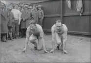  ?? THE ASSOCIATED PRESS ?? In this March 29, 1928, file photo, American sprinters and Olympic champions Jackson Scholz, left, and Charles “Charley” Paddock pose together in their starting positions at New York’s Columbia University.