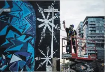  ?? CHRISTOPHE­R KATSAROV THE CANADIAN PRESS ?? Anthony Ricciardi spray paints the eastern facade of a commercial establishm­ent on Bathurst Street in Toronto.