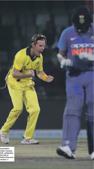  ?? AP ?? Australia’s Adam Zampa, left, celebrates the fall of Rohit Sharma’s wicket