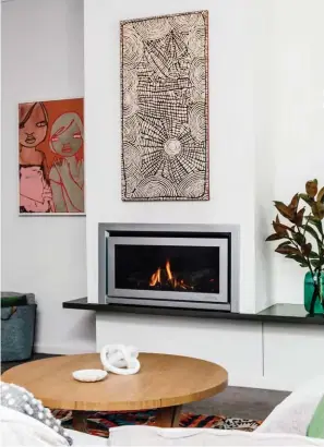  ??  ?? STYLE TO BURN Rebecca chose the Escea DL850 gas fireplace with a ceramic log fuel bed. Its inset Titanium Silver fascia has a traditiona­l appeal and looks as striking when the fire’s turned off as it does when it’s ablaze.