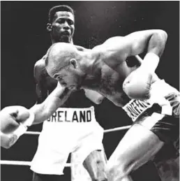  ??  ?? THIN AND DANGEROUS: Breland is in inspired form as thrashes the worst of Honeyghan in 1990 [above] and, in retirement, enjoys the company of Riddick Bowe[below right] and Michael Bentt [below left]