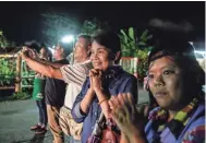  ?? LAUREN DECICCA/GETTY IMAGES ?? Onlookers cheer as ambulances carry boys rescued from a cave to a hospital in Chiang Rai, Thailand. Divers successful­ly brought out the first four of the 12 boys and their soccer coach Sunday morning.