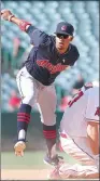  ??  ?? Francisco Lindor of the Cleveland Indians tracks his throw to first base to complete a double play and end the sixth inning after forcing out Mike Trout of the Los Angeles Angels on Thursday at Angel Stadium in Anaheim, California.