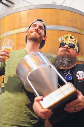  ?? COURTESY OF BOXING BEAR BREWING CO. ?? Boxing Bear Brewing Co. assistant brewer Dylan Davis, left, and head brewer and co-owner Justin Hamilton celebrate their win at the 2019 New Mexico Brewers Guild IPA Challenge.