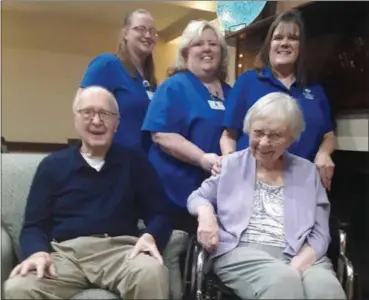  ?? JEAN BONCHAK — THE NEWS-HERALD ?? Desirae Johnston, top left, Regina Mesa and Kerri Williamson are Hospice of the Western Reserve team members and caregivers for Janice Wright, bottom right, who has Alzheimer’s disease and congestive heart failure. Also pictured is Paul Wright, Janice’s husband.