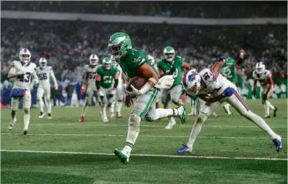  ?? TIM NWACHUKWU/GETTY IMAGES ?? Jalen Hurts raced in from 12 yards to complete Philadelph­ia’s comeback in overtime.