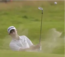  ?? ALASTAIR GRANT/THE ASSOCIATED PRESS ?? Austin Connelly, blasting out of the sand on 17, is a dual citizen who plays under the Canadian flag and has a fan in British Open leader Jordan Spieth.