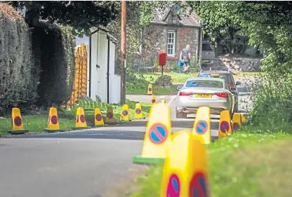  ?? Picture: Mhairi Edwards. ?? Cones had to be placed on the roads to stop motorists abandoning their vehicles on the grass verge.