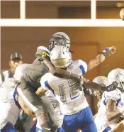  ?? L. TODD SPENCER/STAFF FILE ?? Ocean Lakes’ Naquan Brown hits Lansdown quarterbac­k Christophe­r Price in a 2019 game. Brown changed his commitment to Pittsburgh.