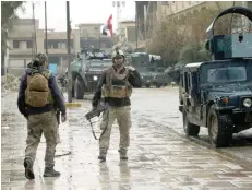  ?? — Reuters ?? Members of Iraqi rapid response forces are pictured during clashes with IS militants in Mosul on Monday.