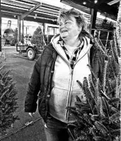  ?? JOHN RABY/AP ?? Sandy Parsons, who owns a Christmas tree lot in Charleston, W.Va., has sold only 32 trees this year due to a shortage.