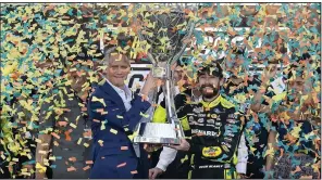  ?? (AP/Darryl Webb) ?? Ryan Blaney (right) receives the NASCAR Cup Series Championsh­ip Cup from NASCAR president Steve Phelps (left) after winning it at Phoenix Raceway on Nov. 5 in Avondale, Ariz.