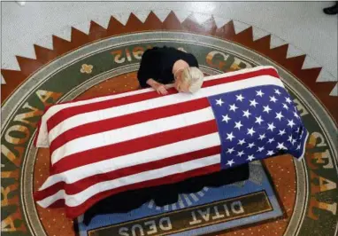  ?? ROSS D. FRANKLIN, POOL — THE ASSOCIATED PRESS ?? Cindy McCain, wife of, Sen. John McCain, R-Ariz. lays her head on casket during a memorial service at the Arizona Capitol on Wednesday in Phoenix.