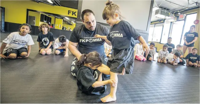  ?? STEVE BOSCH/ PNG ?? Chris Franco, owner and operator of FXP MMA on Fraser Street, instructs his daughter Isla, right, with other students looking on. Franco does not believe in any contact to the head with children.