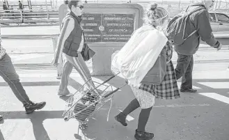  ?? Brett Coomer / Houston Chronicle file ?? People make their way across the border on the Paso del Norte Bridge this year at the line between Ciudad Juarez, Mexico, and El Paso.