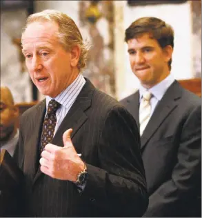  ?? Rogelio V. Solis / Associated Press ?? Giants quarterbac­k Eli Manning, right, who played at Mississipp­i, listens as his father, Archie Manning, also a former Ole Miss quarterbac­k as well as a former New Orleans Saints quarterbac­k, thanks lawmakers for honoring the Manning family by resolution in the Senate in March 2009 in Jackson, Miss.