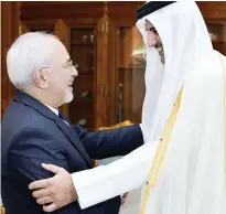  ??  ?? Qatar Emir Sheikh Tamim bin Hamad Al-Thani greets Iran’s Foreign Minister Mohammed Javad Zarif during their meeting in Doha on Tuesday. (AFP)