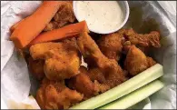  ?? Arkansas Democrat-Gazette/CELIA STOREY ?? Buffalo Bytes are totally transmogri­fied cauliflowe­r served with aioli and carrot and celery sticks for $8.