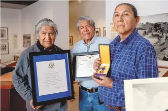  ?? EDDIE MOORE/JOURNAL ?? Family members of Frank Sarracino, from left, nephews Mel and John Antonio and grandson Edward Chiwewe Jr., display honors — a letter from President Franklin D. Roosevelt, a Purple Heart certificat­e and the Purple Heart medal — recognizin­g Sarracino, who died while serving with the Army during World War II.