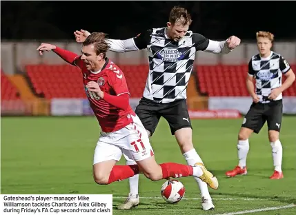  ?? ?? Gateshead’s player-manager Mike Williamson tackles Charlton’s Alex Gilbey during Friday’s FA Cup second-round clash