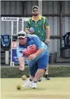  ?? PHOTO: LINDA ROBERTSON ?? Kaikoura bowler Josh Boyd is watched by his opponent, Aaron Wilson (Australia), during the first round of the North East Valley Invitation­al Singles yesterday.