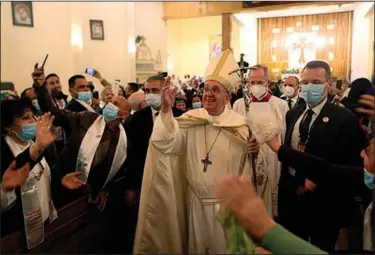  ?? (AP/Khalid Mohammed) ?? Congregant­s chant, “Viva, viva Papa!” as Pope Francis leaves the Chaldean Catholic cathedral in Baghdad on Saturday after delivering a sermon on common good.