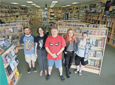  ?? PHOTOS BY BARBARA J. PERENIC/COLUMBUS DISPATCH ?? The Laughing Ogre at 4258 N. High St. won the prestigiou­s Eisner award, which goes to one comic book store in the world every year. Store owner Gib Bickel, center, with store managers, from left, Andrew Burgess, Lauren Mccalliste­r, Trish Smith and Sarah Edington.