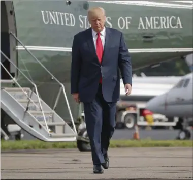  ?? PABLO MARTINEZ MONSIVAIS — THE ASSOCIATED PRESS ?? President Donald Trump walks across the tarmac from Marine One to board Air Force One at Morristown Municipal Airport, Monday, Aug. 14, 2017 in Morristown, N.J. Trump is traveling back to Washington to sign an executive order at the White House and...
