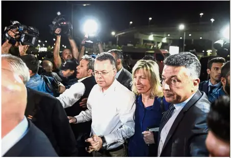  ?? — AFP ?? Free man: Brunson (centre) arriving at Adnan Menderes airport in Izmir, after being freed following a trial in a court in Aliaga in western Izmir province.