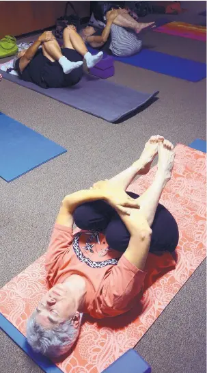  ?? GREG SORBER/JOURNAL ?? Under subdued light Marcy Dorchester of Albuquerqu­e participat­es in a yoga class at the Palo Duro Senior Center.