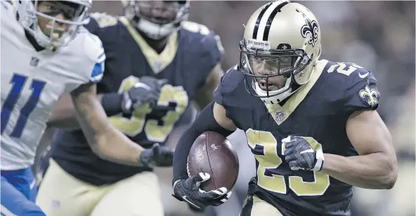  ?? — GETTY IMAGES ?? Marshon Lattimore of the New Orleans Saints returns an intercepti­on for a touchdown against the Detroit Lions during NFL action Sunday at the Superdome. The Saints defence scored three touchdowns and forced five turnovers in a 52-38 win.