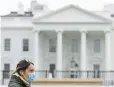  ?? Patrick Semansky, The Associated Press ?? A woman wearing a face mask walks past the White House on Wednesday in Washington, D.C.