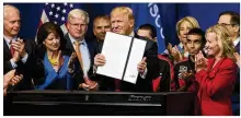  ?? MILWAUKEE JOURNAL SENTINEL ?? President Donald Trump signs the “Buy American, Hire American” executive order on April 18 during a visit to Snap-on Inc. in Kenosha, Wis. The orders require federal agencies to buy more goods and services from U.S. companies and workers.