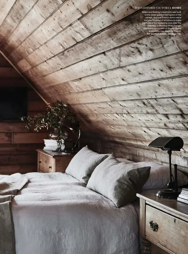  ??  ?? Helen and Rodney’s bedroom was built in the steep gabled roof space of the cottage. Antique French doors were installed instead of windows to make the most of the sweeping view over the treetops in Wombat State Forest. The bed linen is a mix of Sheridan and linen Helen has made for Found. For stockist details, see page 138.